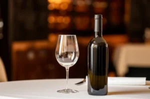 Cute-3D-render-of-a-wine-bottle-on-a-table-with-a-glass,-representing-corkage.