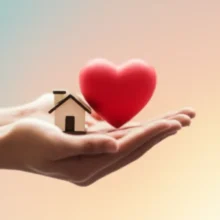 Two-hands-gently-holding-symbols-of-a-home-and-a-heart,-representing-social-welfare-and-community-support.