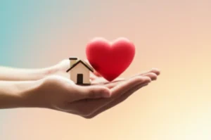 Two-hands-gently-holding-symbols-of-a-home-and-a-heart,-representing-social-welfare-and-community-support.