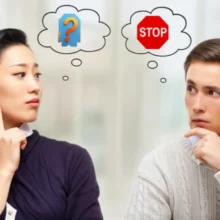 A-cute-3D-image-of-two-people,-one-with-a-'stop'-sign-thought-bubble,-indicating-a-cultural-communication-misunderstanding.