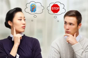 A-cute-3D-image-of-two-people,-one-with-a-'stop'-sign-thought-bubble,-indicating-a-cultural-communication-misunderstanding.